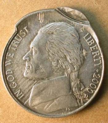 Collar break error showing a fin of extra metal at the coin rim