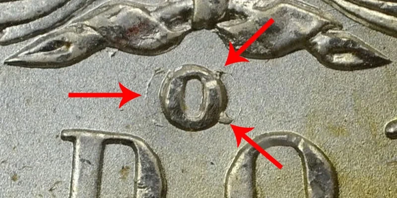 Close-up of the O/CC mint mark — arrows indicate the CC ghost beneath the O