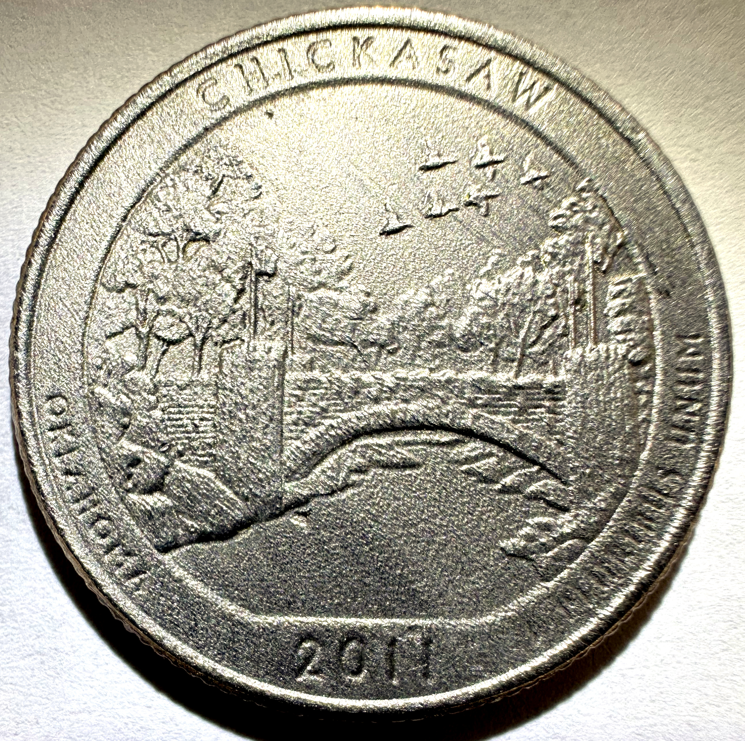 Acid-damaged coin with etched, pitted surface