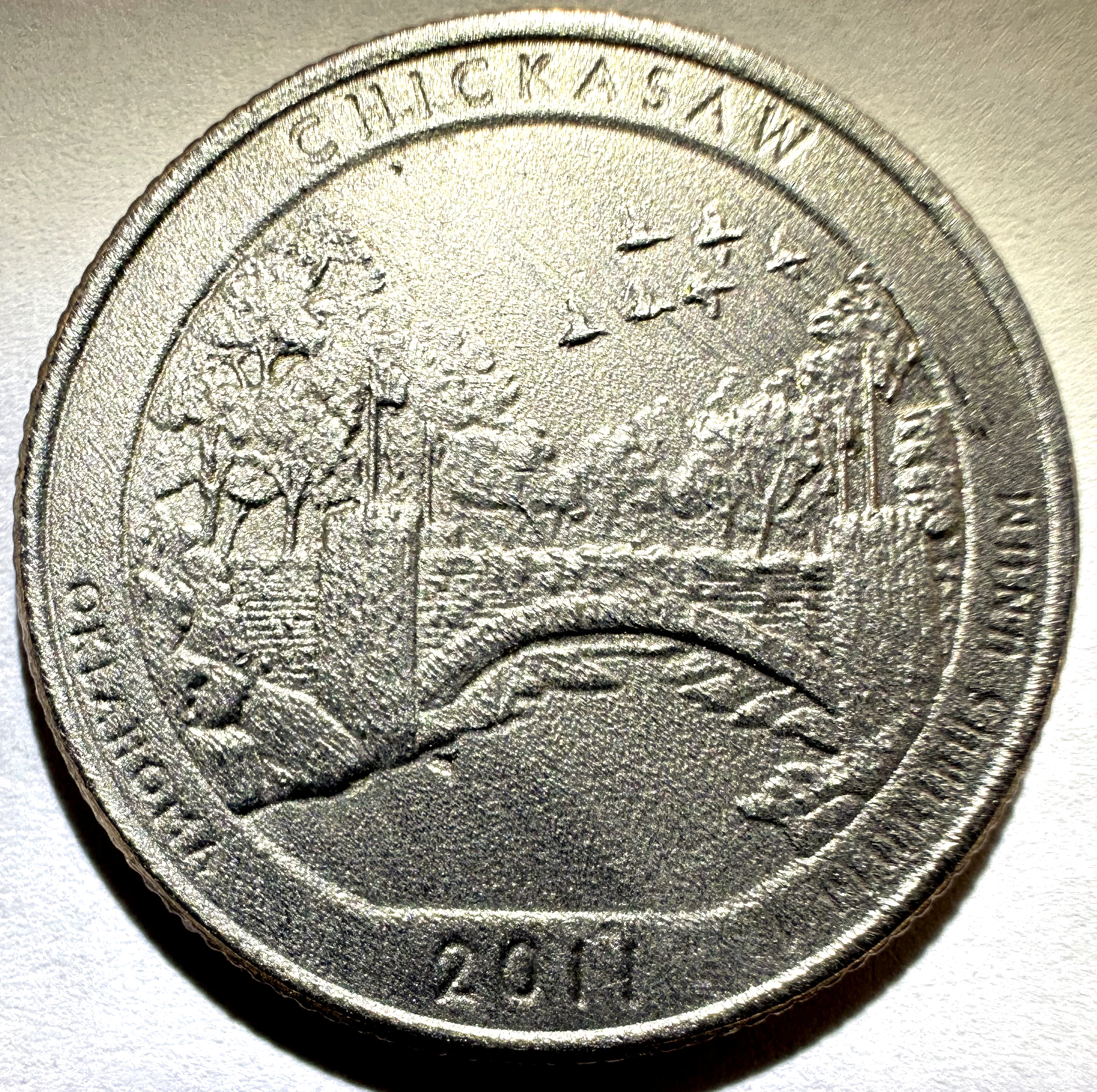 Acid-damaged coin with etched, pitted surface