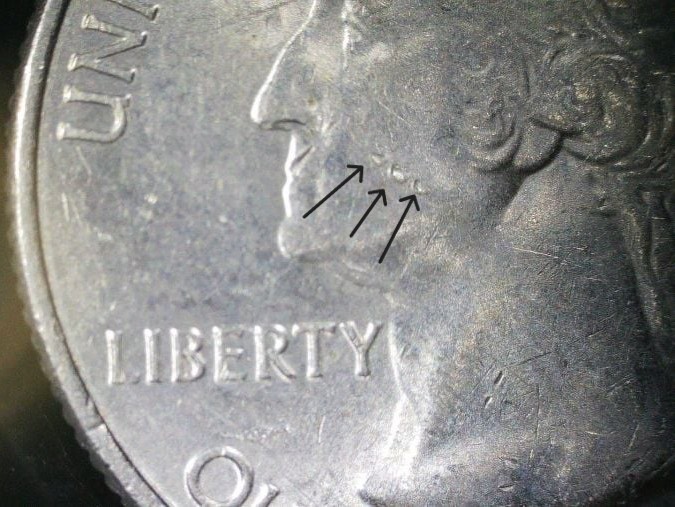 Contact marks and bag marks on a coin