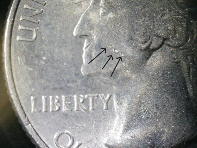 Contact marks and bag marks on a coin