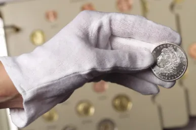 Proper coin handling — holding by the edges only