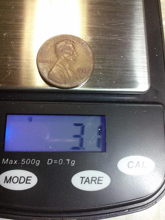 1982 copper cent on a precision scale showing 3.1 gram weight