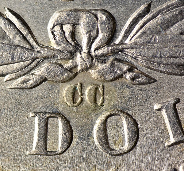 Altered coin with added mint mark showing glue residue under magnification