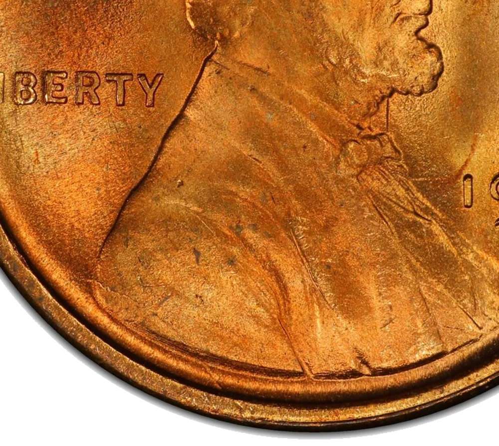 1909 VDB Lincoln cent, close-up of the lower bust and rim — a raised die crack runs from the back of Lincoln's shoulder down to the rim near 6:30