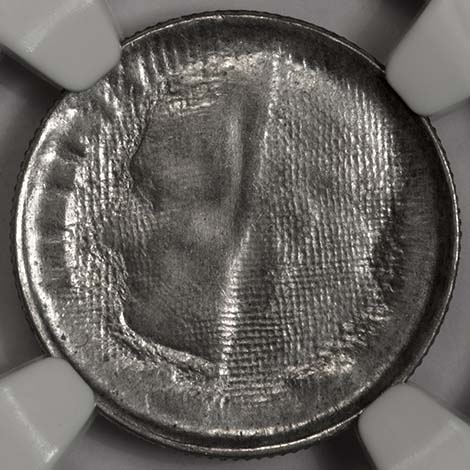 Roosevelt dime struck through cloth — the fabric weave pattern covers the obverse